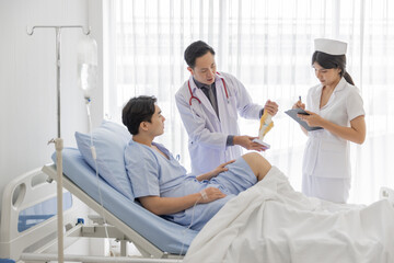 Obraz premium Professional orthopaedist male doctor and nurse visiting checking examine knee condition male patient at hospital