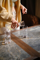 the girl pours water into a glass