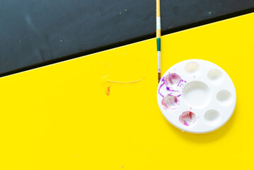 A palette for coloring on a yellow background.