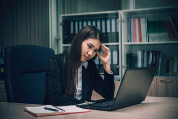 Asian woman working in office,young business woman stressed from work overload with a lot file on the desk,Thailand people thinking something