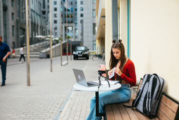 Freelance woman in a summer cafe preparing to work.