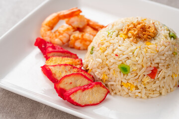 Yangzhou fried rice is a popular Chinese-style wok fried rice dish. Asia Chinese China food cuisine. Authentic Yangzhou fried rice with egg, fresh prawn and Red Roast Pork.