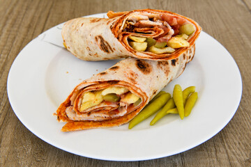 Lavash doner kebab ( zurna tavuk et doner durum )  or shawarma sliced in plate isolated. 