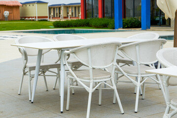 White table and chair arrangement for outdoor tent party