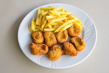 Fried Chicken breast hot crispy strips crunchy chicken tenders  isolated on white background.Nuggets isolated on white background on a plate