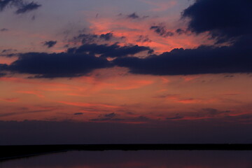 Fototapeta na wymiar Sunset on the calm water of tha saline