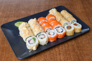 Variety of sushi rolls are presented on a plate, showcasing the colorful and fresh ingredients.