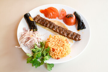 Beef steak grill with rice pilaf, fried potatoes, grilled pepper and tomatoes.Mix Platter with Beef rips, Cutlets, Potatoes and Sauces.