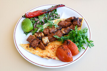 Beef steak grill with rice pilaf, fried potatoes, grilled pepper and tomatoes.Mix Platter with Beef rips, Cutlets, Potatoes and Sauces.