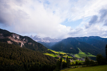 Fototapeta na wymiar Sunset and rainbow in Val Di Funes, Dolomites, Alps, Italy