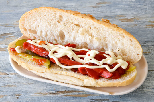 Close-up shot of Izmir's famous Turkish Traditional Kumru Sandwich, Ceşme Kumru, patso ingredients ready to eat salami, soudjouk, tomato, cheddar cheese and fried cheese. Yengen sandvic.