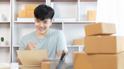 Man was happy after receiving an order from an internet customer, New business style for young people working at home and owning businesses, Online shopping SME entrepreneur, Packing box, Sell online.