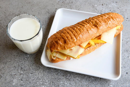 Close-up shot of Izmir's famous Turkish Traditional Kumru Sandwich, Ceşme Kumru, patso ingredients ready to eat salami, soudjouk, tomato, cheddar cheese and fried cheese. Yengen sandvic.