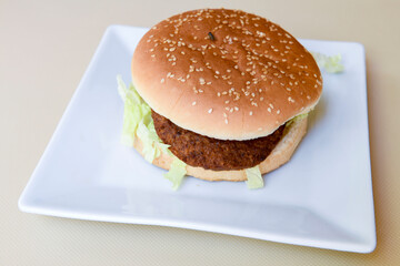 Big tasty burger with beef cutlet on a plate. Crispy chicken burger.