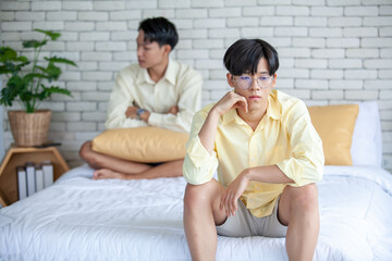 Asian gay couples are quarreling, angry or sad on bed in home,  LGBTQ concept.