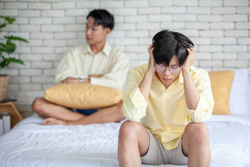 Asian gay couples are quarreling, angry or sad on bed in home,  LGBTQ concept.