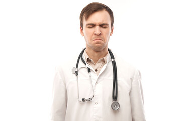 Fototapeta premium Portrait of angry doctor in white medical coat with stethoscope upset face screaming on white background with copy space