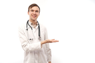 Handsome doctor in white medical coat with stethoscope holding something isolated on white...