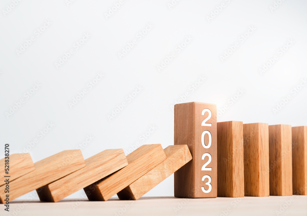 Poster close-up the 2023 year numbers calendar on wooden cube blocks stops falling blocks and collapsing do