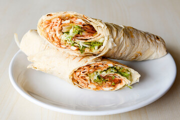 Lavash doner kebab ( zurna tavuk et doner durum )  or shawarma sliced in plate isolated. 