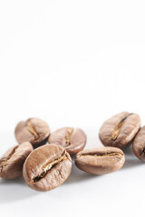 Roasted coffee beans isolated close up on white background, clipping path