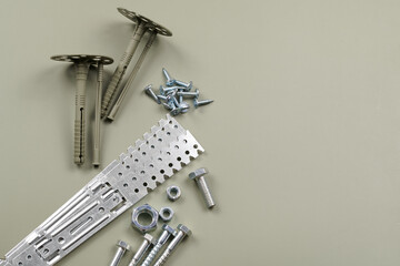 Set of bolts nuts nails metal fasteners. Consumable hardware tools. assortment steel screws collection close up background