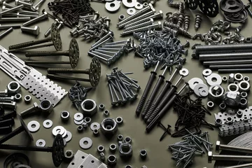 Fotobehang Set of bolts nuts nails metal fasteners. Consumable hardware tools. assortment steel screws collection close up background © amixstudio
