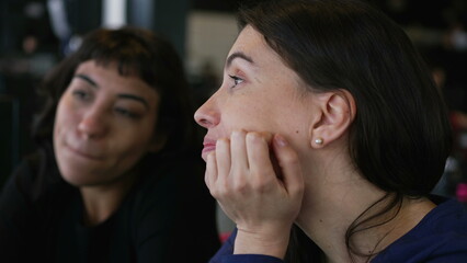 Female friends talking at restaurant chatting. Two women in conversation