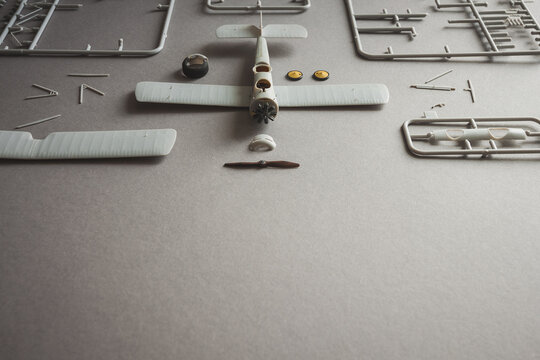 Scale model of the airplane fighter with details. Plastic assembly kit. Top view. Copy space