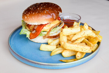 Big tasty burger with beef cutlet on a plate. Crispy chicken burger.