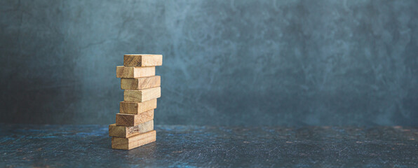 Wooden block stack concept of prevent collapse or crash of financial business and risk management...