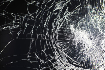 Crack on the glass. Broken screen. Broken phone. Cracked glass background. White cracks in the glass.