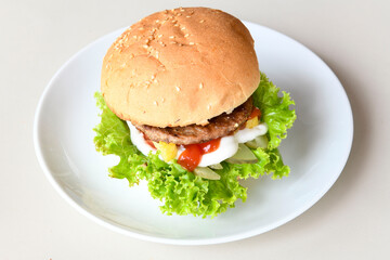 Big tasty burger with beef cutlet on a plate. Crispy chicken burger.