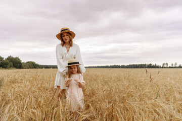 Mom and daughter in a wheat field