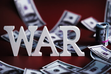 WAR, word written in wooden alphabet letters on red background. The concept of a terrible war destroying country.