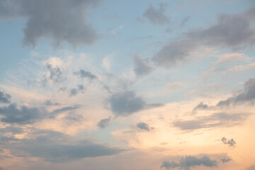 Naklejka na ściany i meble Blue sky with golden light and clouds at sunset.