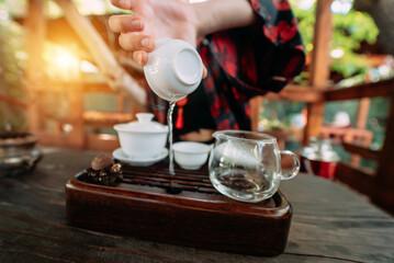 Young girl pouring water from cup close-up