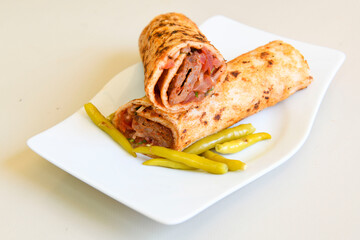 Grilled Turkish Adana, Urfa  Kebab with grilled vegetables, onion and rice on plate. Adana durum.