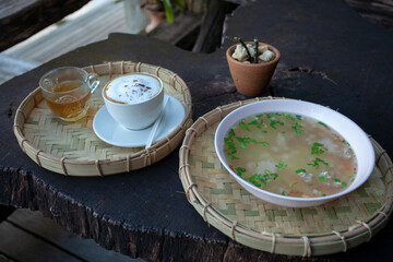 Breakfast served with boiled rice and coffee on old wooden table