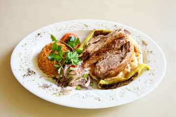 Beef steak grill with rice pilaf, fried potatoes, grilled pepper and tomatoes.Mix Platter with Beef rips, Cutlets, Potatoes and Sauces.