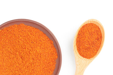Red chili pepper in clay plate and wooden spoon isolated on white. Macro. Flat lay. Vegetarian food concept