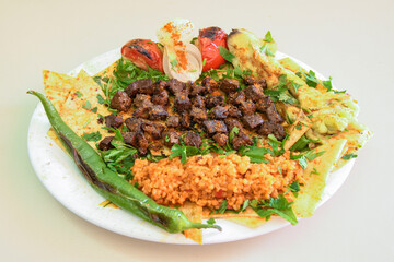 Beef steak grill with rice pilaf, fried potatoes, grilled pepper and tomatoes.Mix Platter with Beef rips, Cutlets, Potatoes and Sauces.