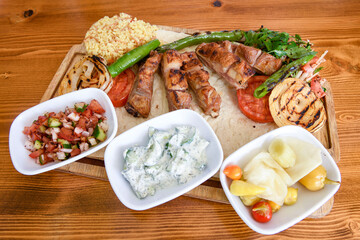 Beef steak grill with rice pilaf, fried potatoes, grilled pepper and tomatoes.Mix Platter with Beef rips, Cutlets, Potatoes and Sauces.