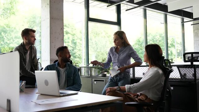 Group of millennial male and female creative occupation casual conversation meeting with cheerful and smiling,office friend standing discussion together in office