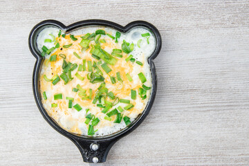 Fun food for kids. omelet for children in a frying pan. Healthy eating.