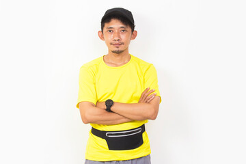 asian sporty man dressed in yellow tshirt listening music isolated on white background