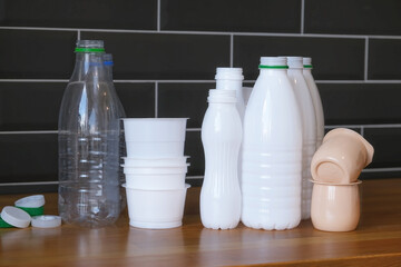 plastic bottles and packaging from drinks and food, bottle caps are sorted in the kitchen at home, separate waste collection and recycling of garbage