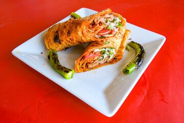 Lavash doner kebab ( zurna doner durum )  or shawarma sliced in plate isolated. 