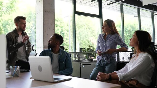 Group of millennial male and female creative occupation casual conversation meeting with cheerful and smiling,office friend standing discussion together in office