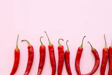 Fotobehang Red chilli pepper on a pink background, vegetable pattern. Pattern of food. Top view,flat lay © ALEXSTUDIO